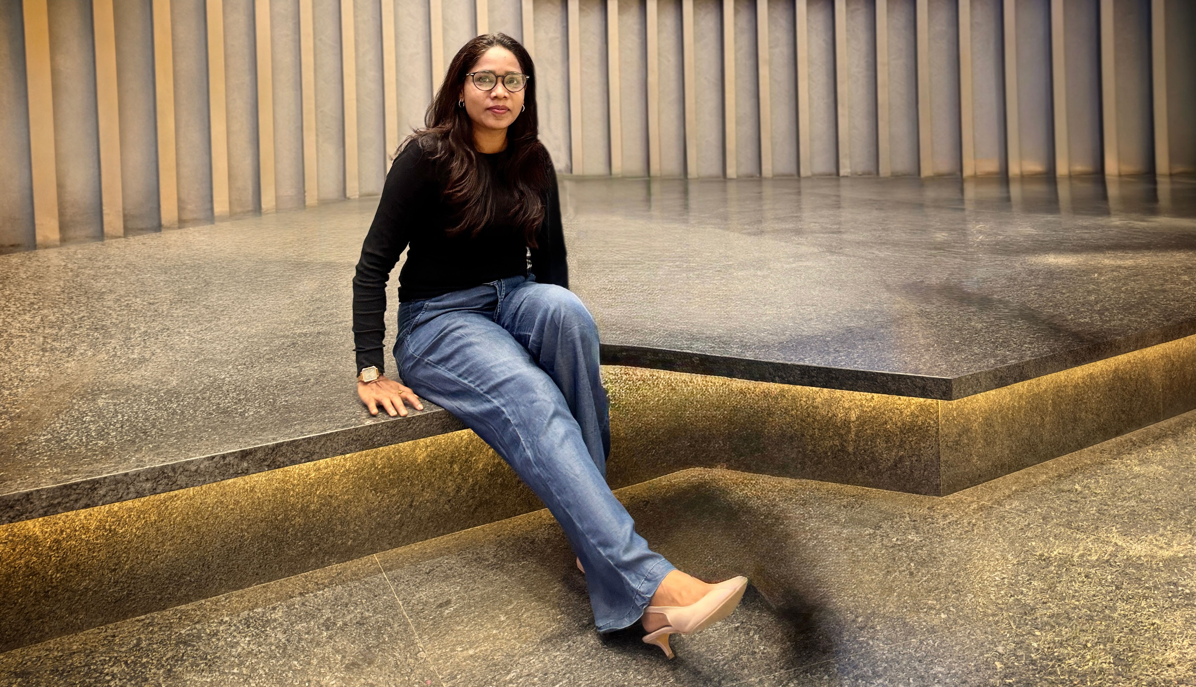 Komal Loat seated in a modern interior